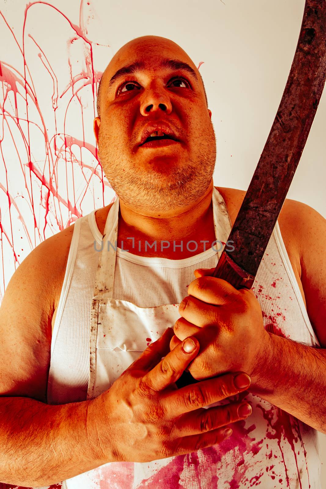 Crazy insane butcher covered with blood.  Harsh lighting for more disturbing feel.