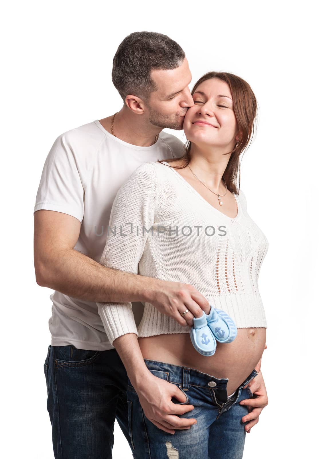 Happy young couple anticipating child birth over white background