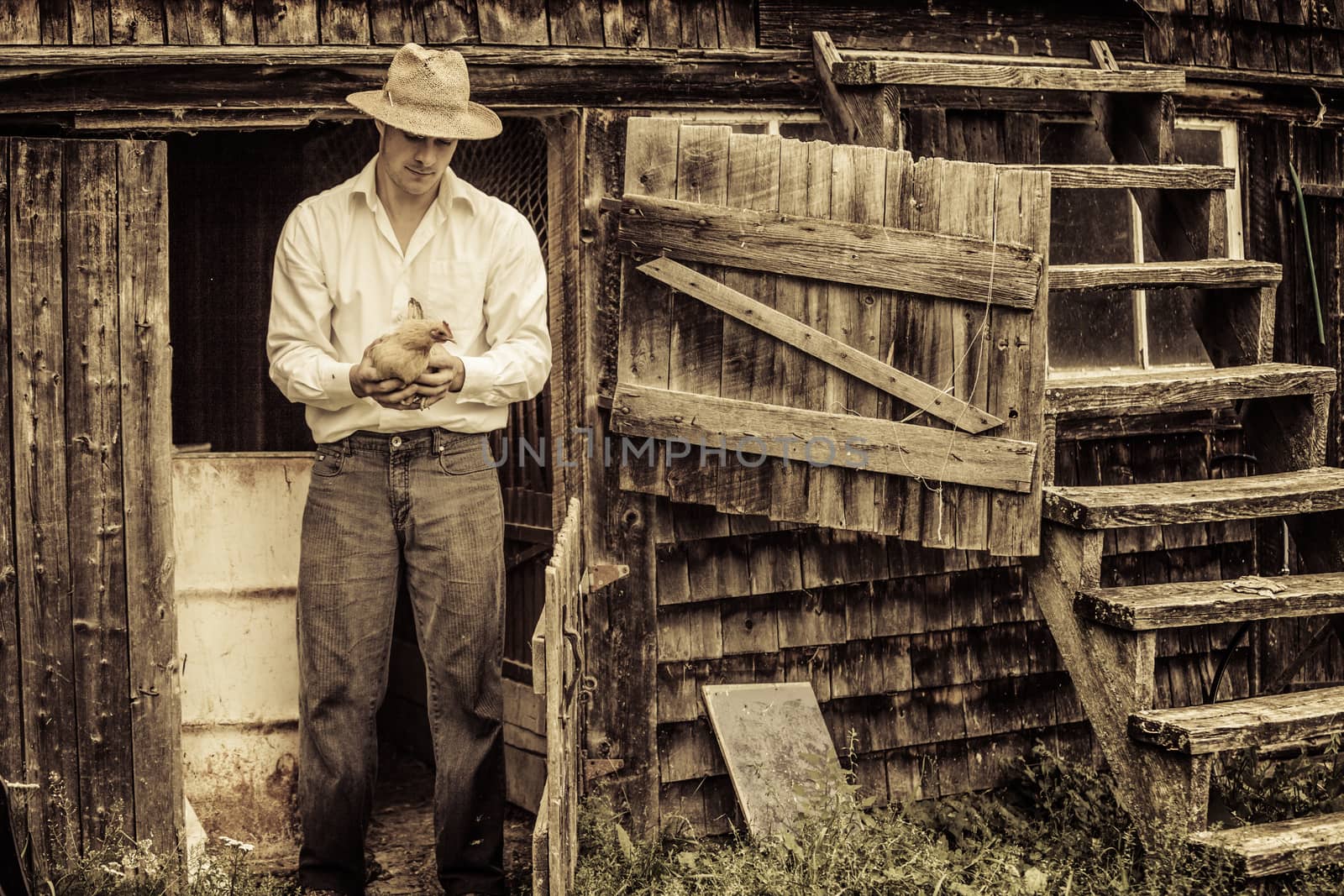 Young Farmer and a Chicken at the Farm