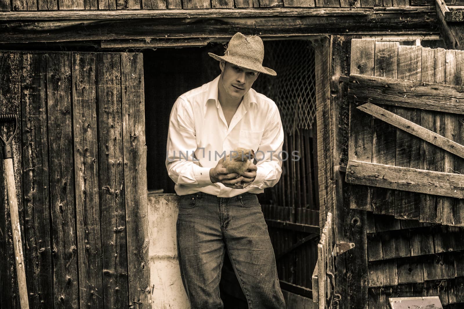 Young Farmer and a Chicken at the Farm