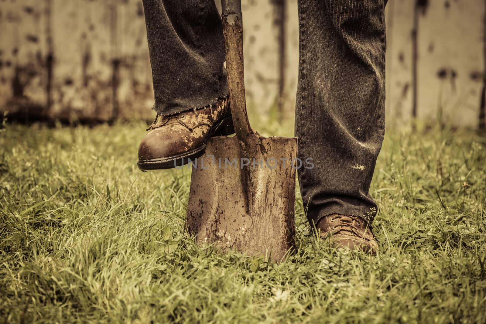 Details of feet and Shovel in front of Barn