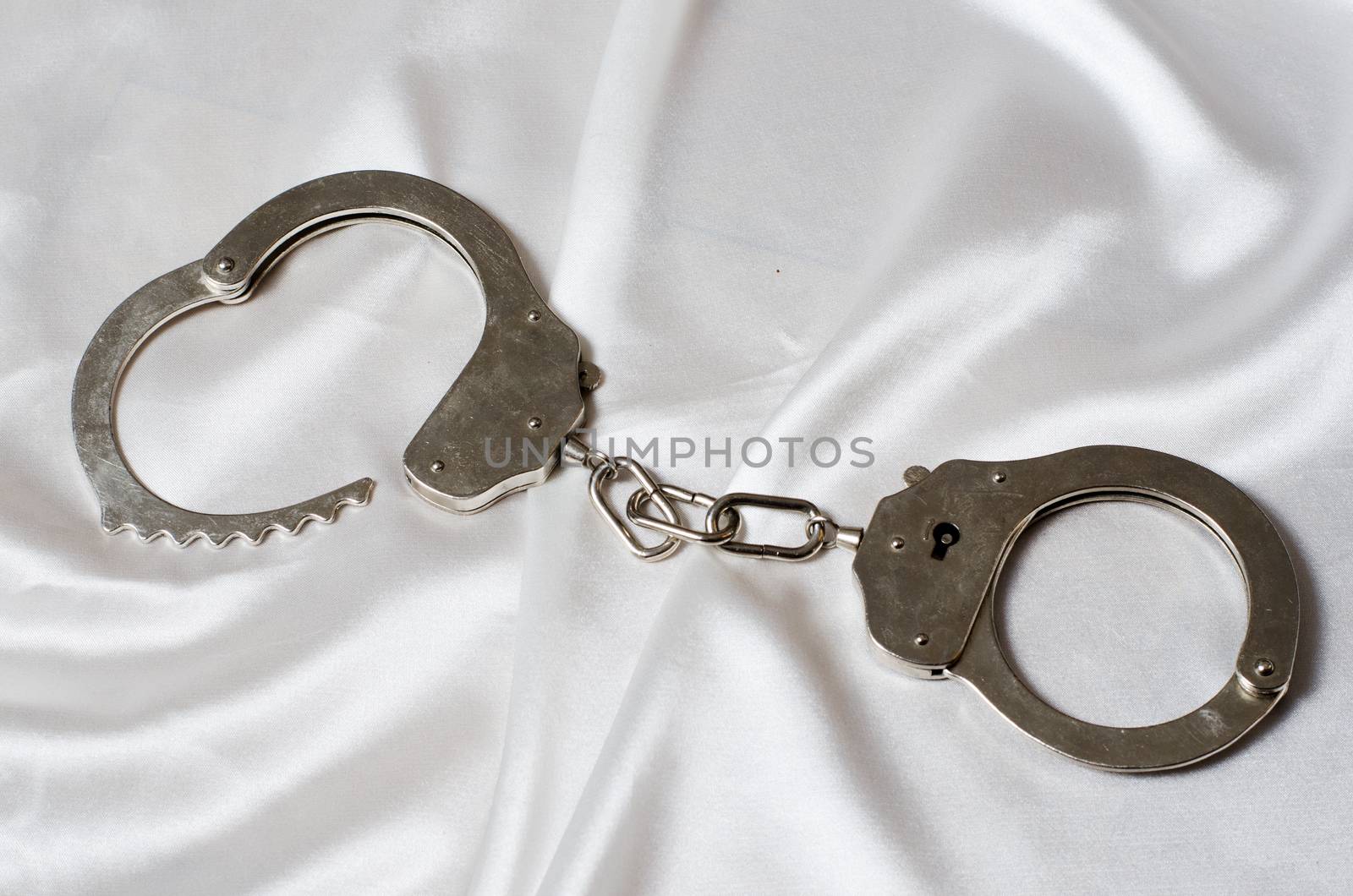 handcuffs on the satin background