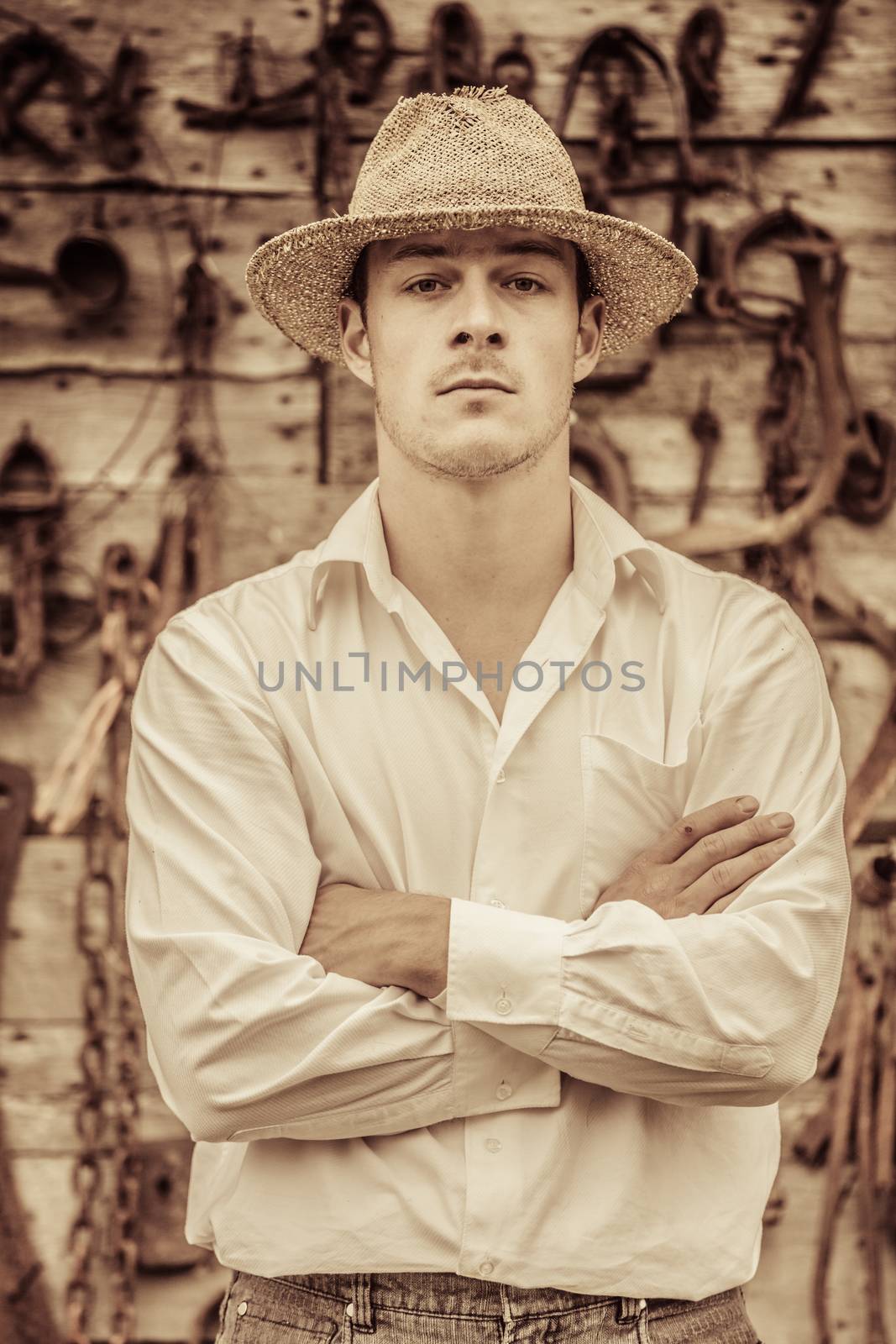 Farmer Portrait in front of a Wall Full with Old Rusty Tools