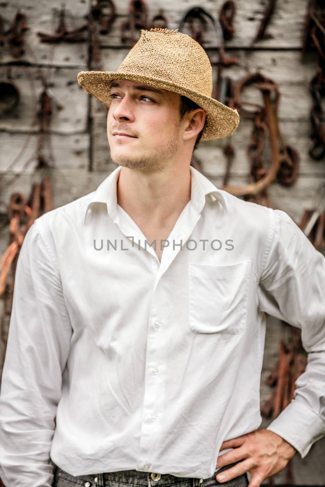 Farmer Portrait in front of a Wall Full with Old Rusty Tools