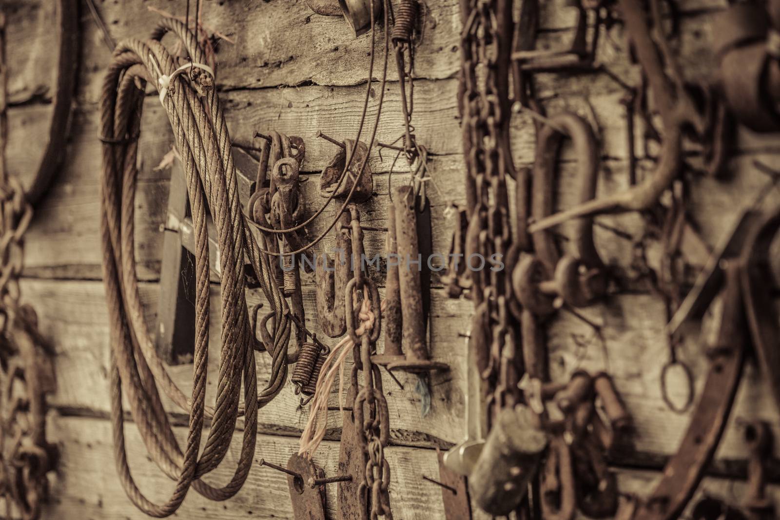 Wall Filled with Old Rusty Tools Hanging on the wall