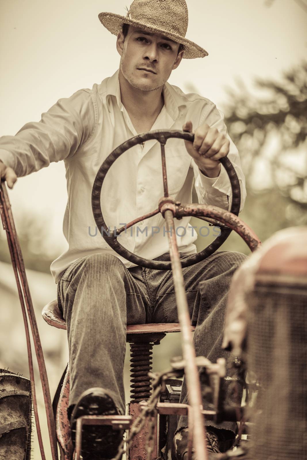 Young Farmer on a Vintage Tractor by aetb