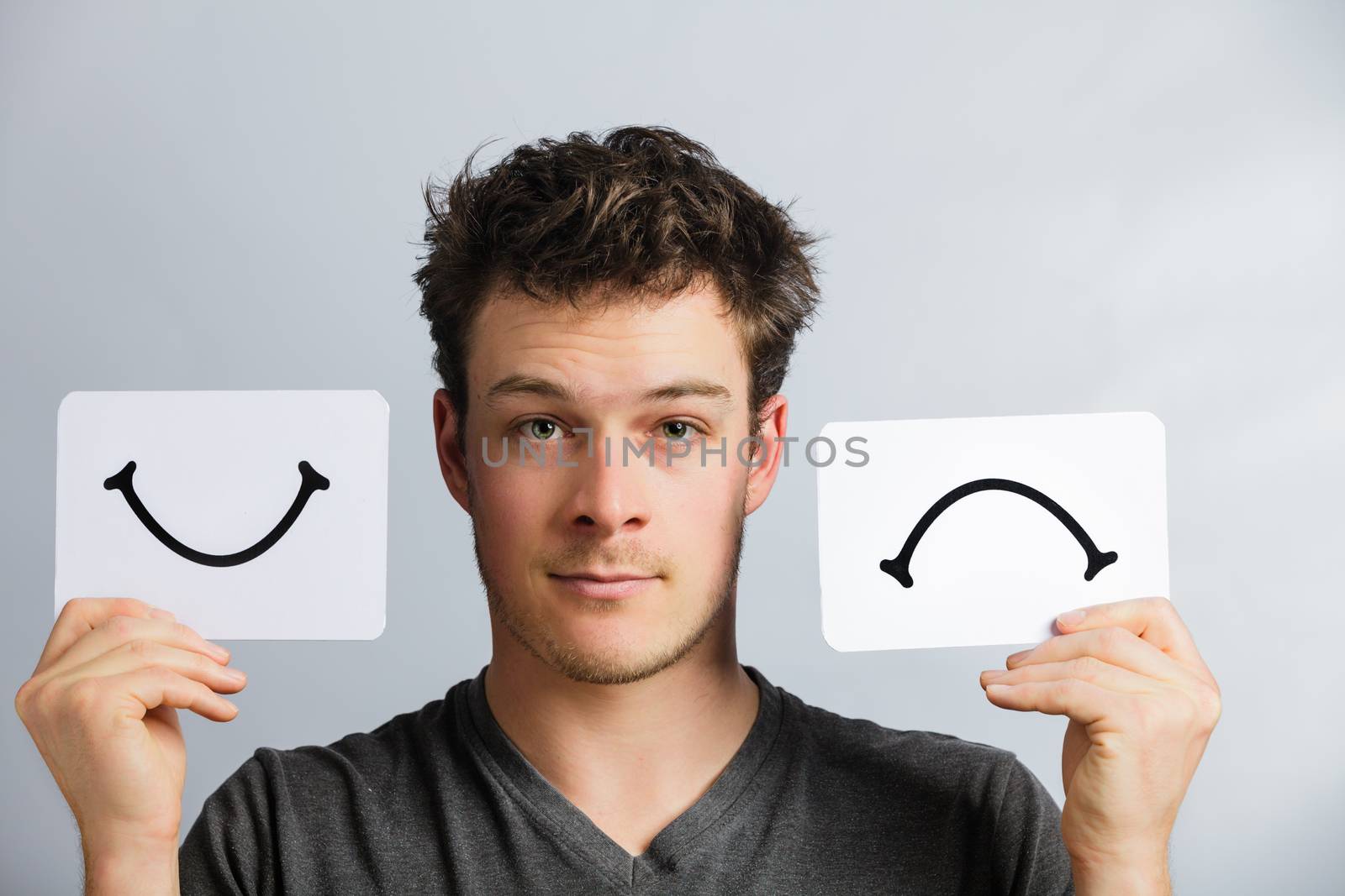 Portrait of a Man Holding Happy and Unhappy Survey Mood Board