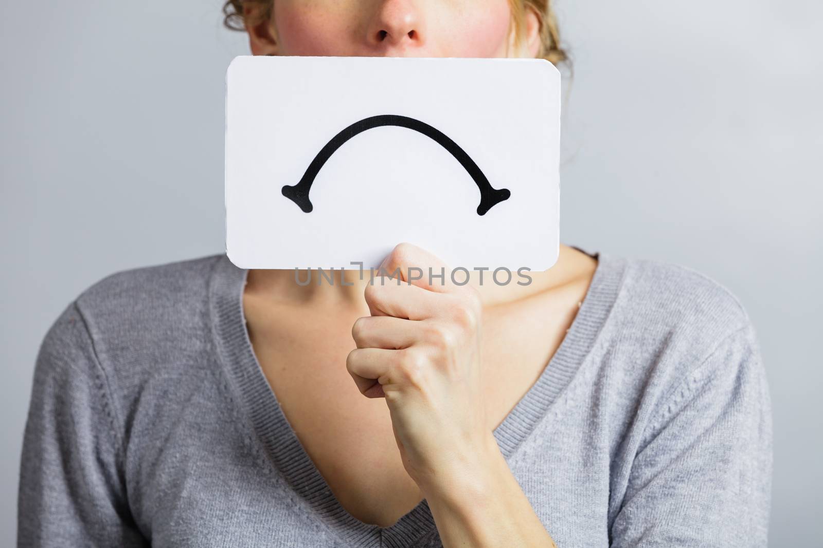 Unhappy Portrait of a Woman Holding a Sad Mood Board