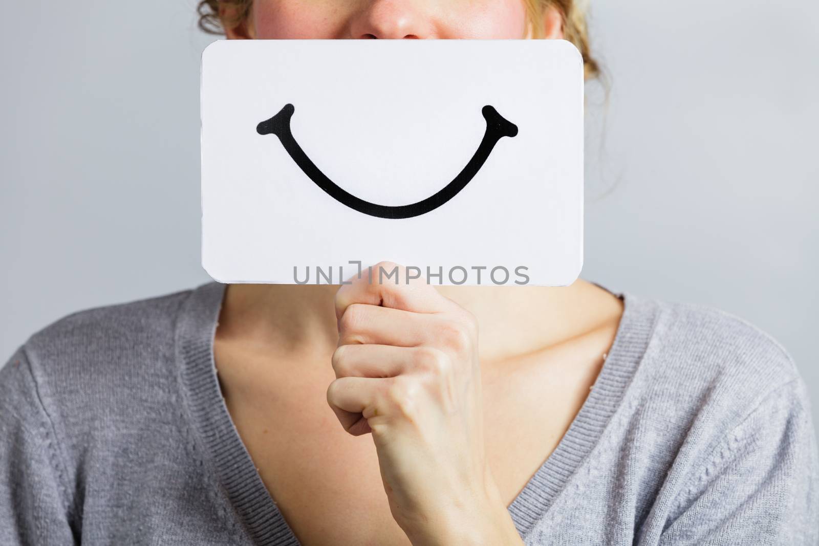 Happy Closeup of a Woman Holding a Smiling Mood Board