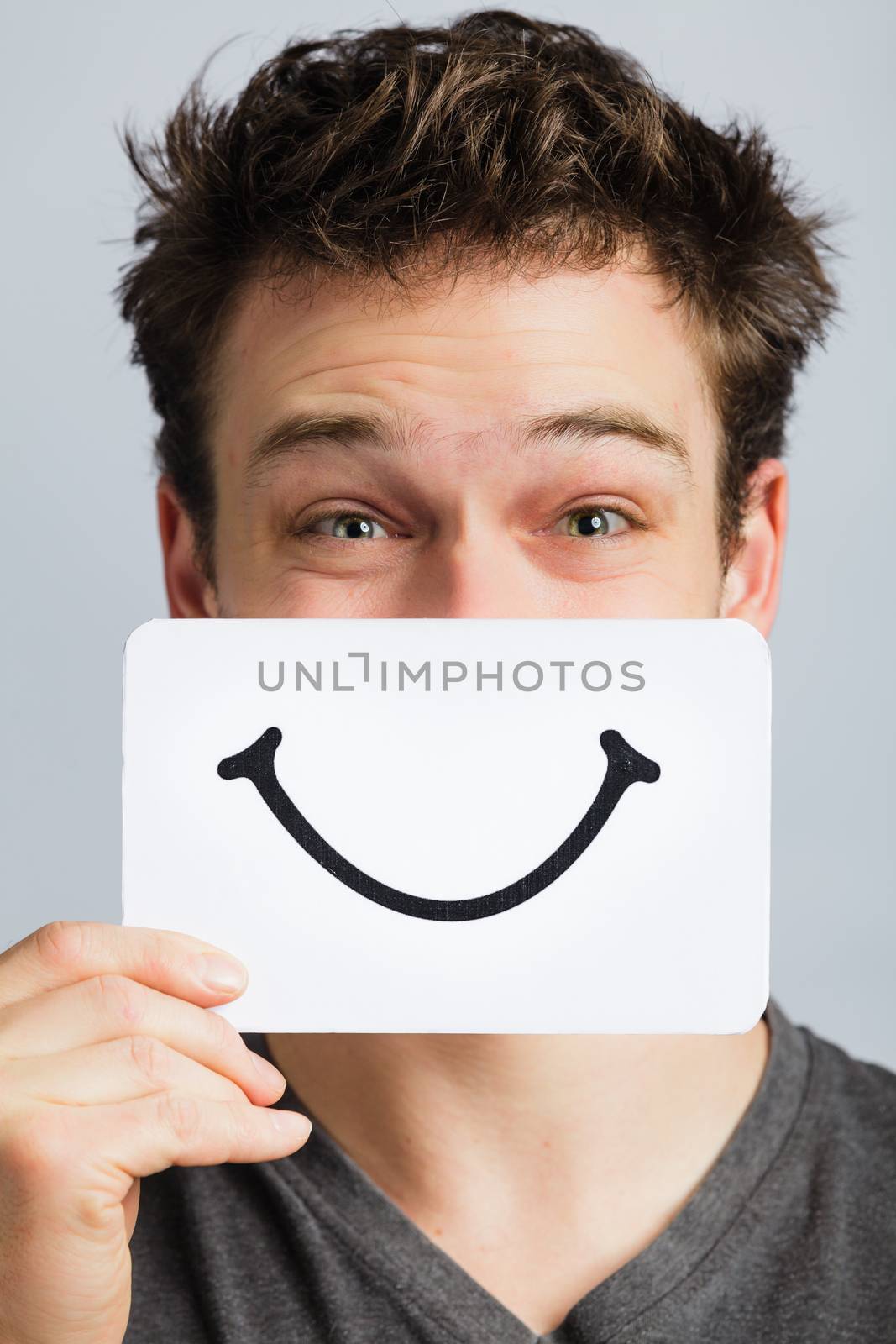 Happy Portrait of a Man Holding a Smiling Mood Board