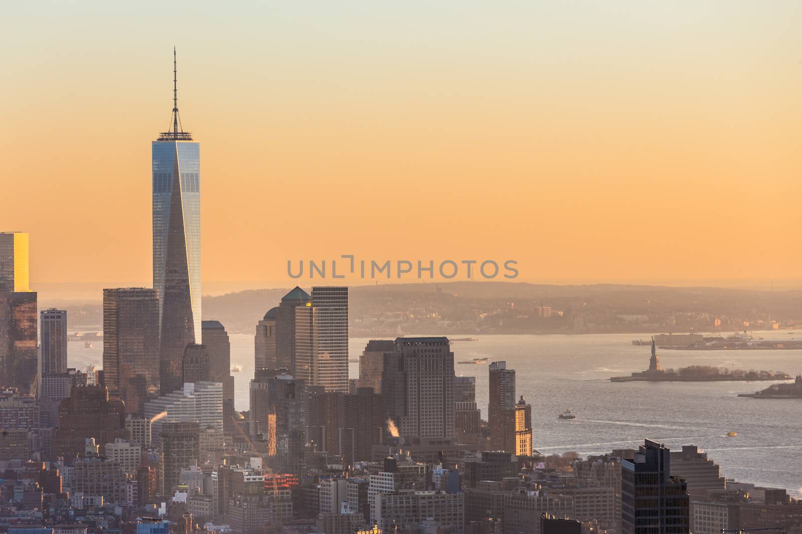 New York City. Manhattan downtown skyline with illuminated Empire State Building and skyscrapers at sunset seen from Top of the Rock observation deck. Vertical composition Fish eye lens shot.