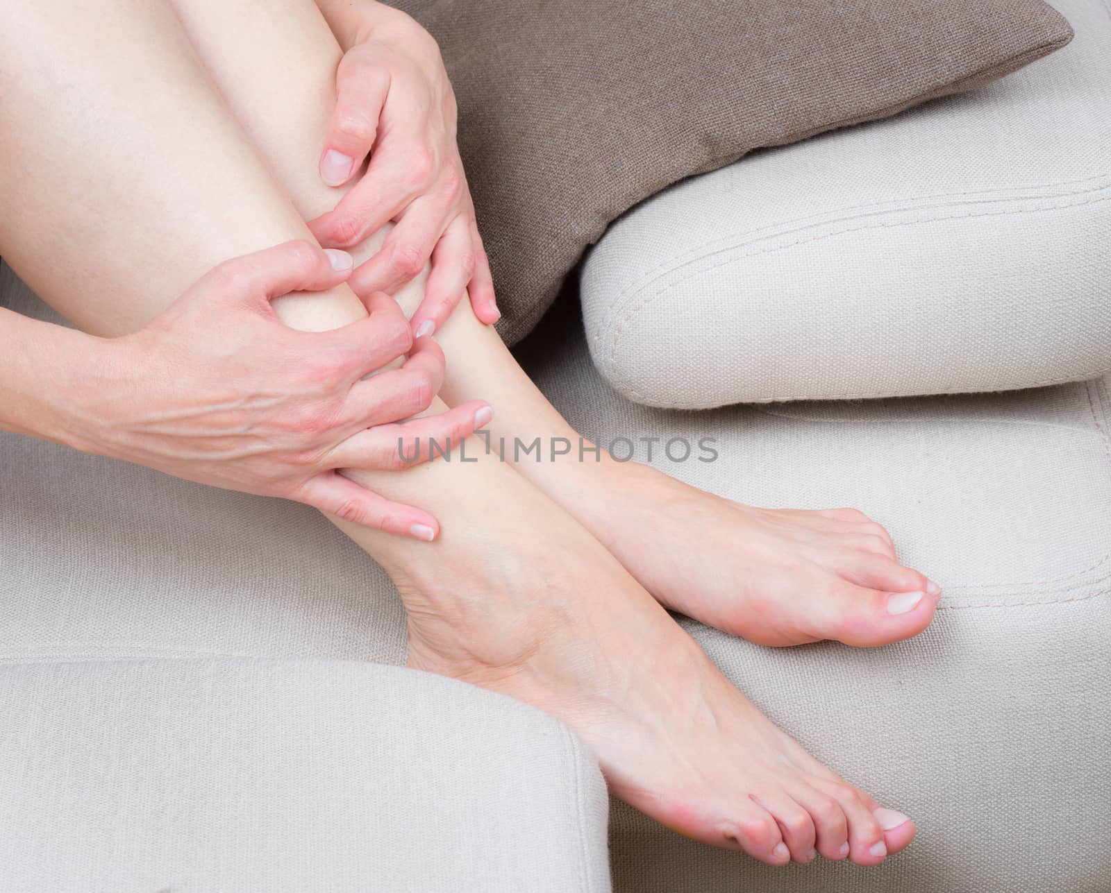 Close up view of tired woman legs on the sofa