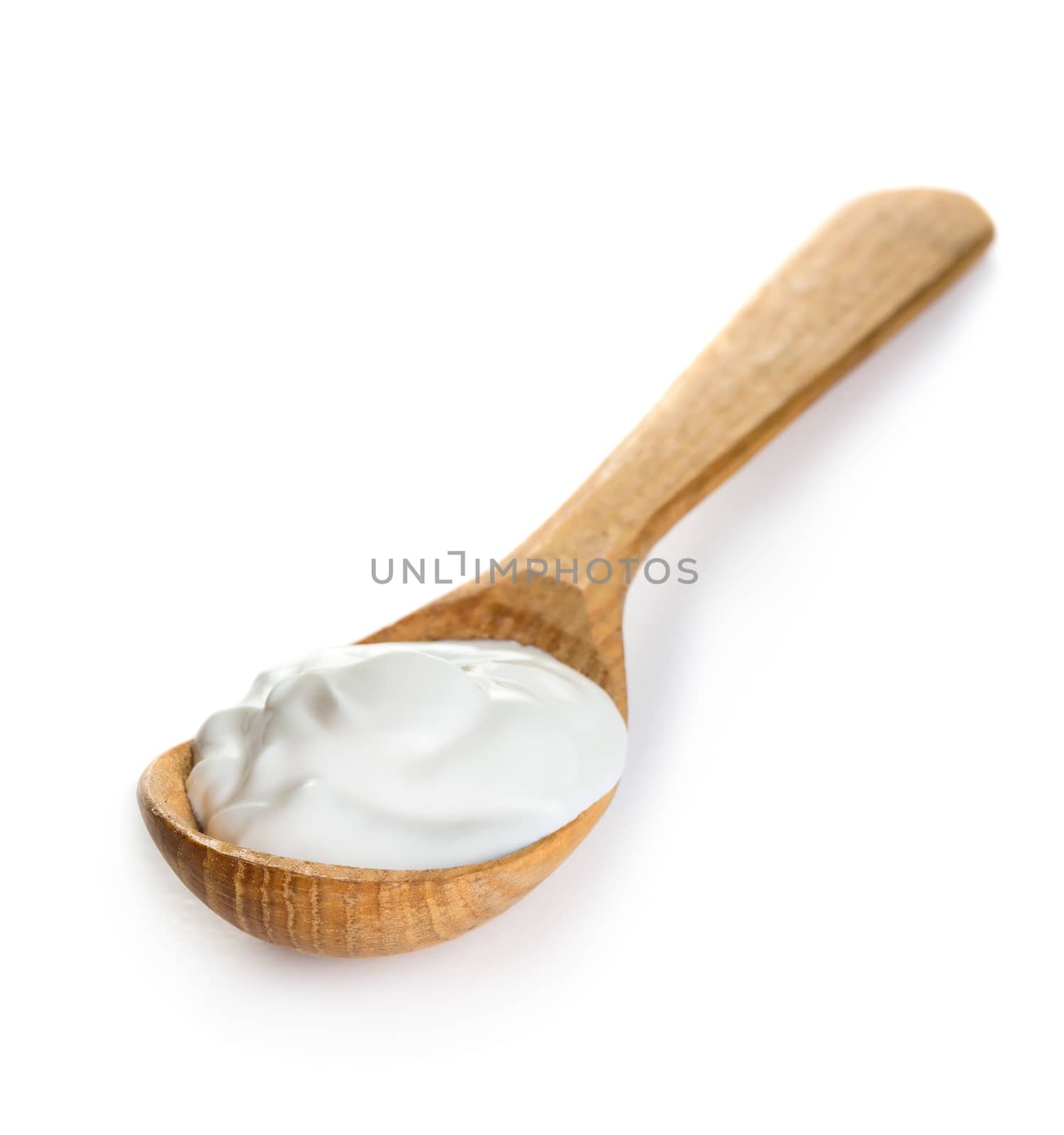 Cream in wooden spoon isolated on white background