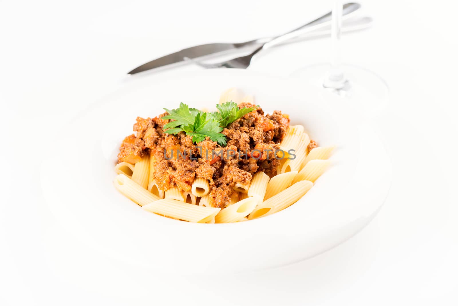 Pasta. Penne Pasta with Bolognese Sauce, Parmesan Cheese and Basil, Fork. Italian Cuisine. Mediterranean food