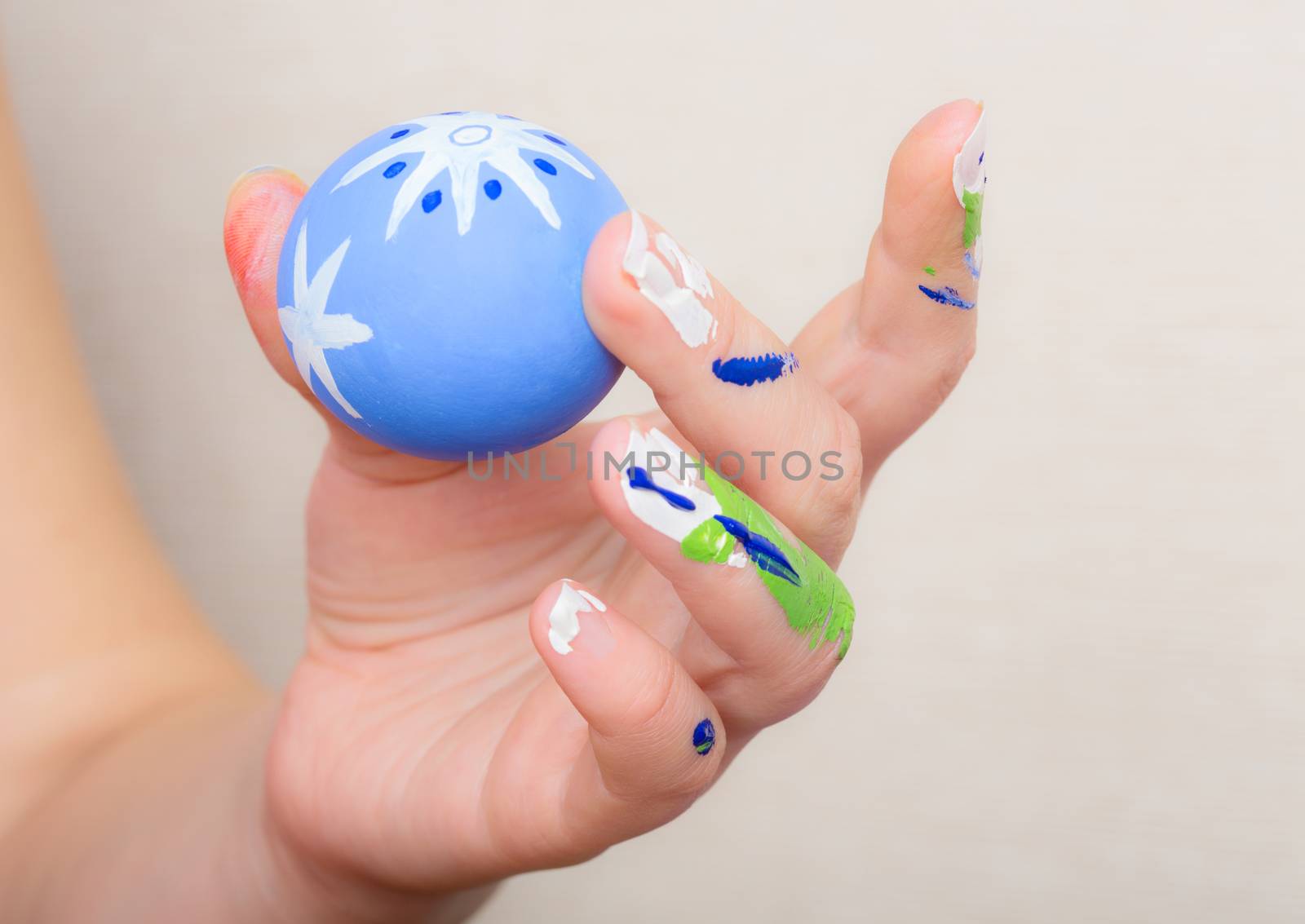 Young woman painting Easter eggs