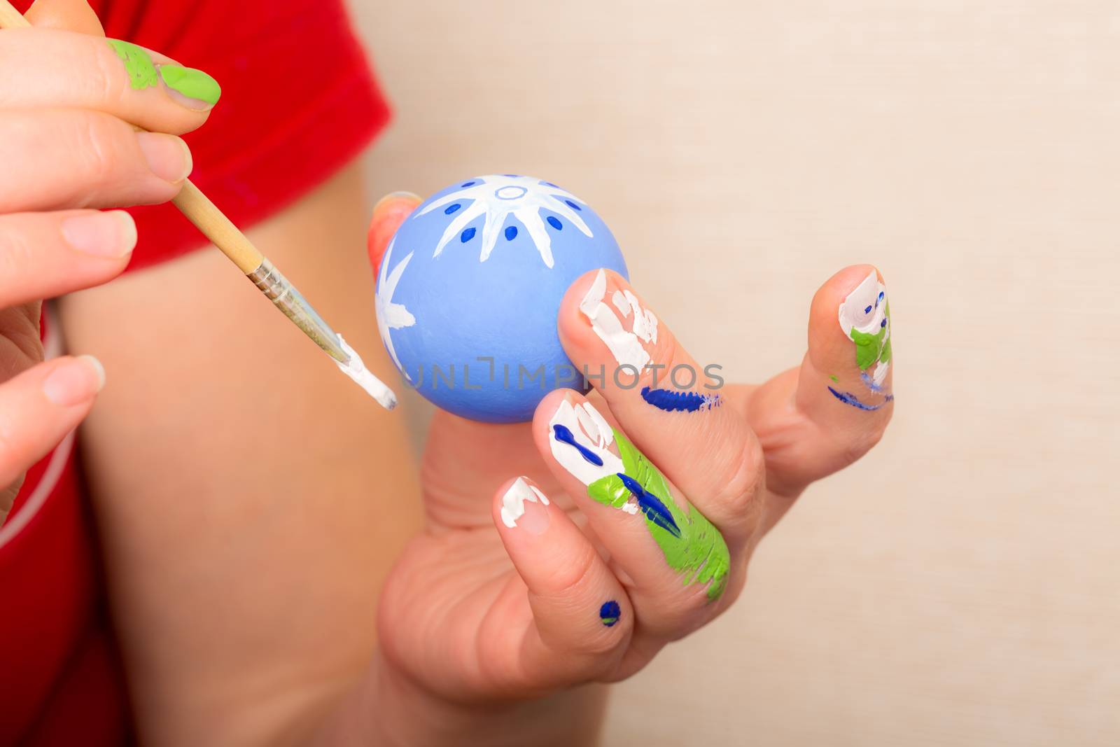 Young woman painting Easter eggs