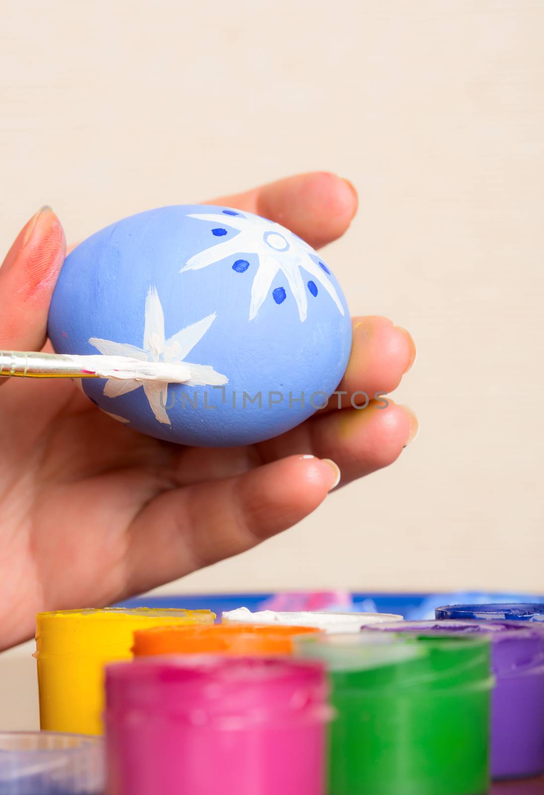 Young woman painting Easter eggs