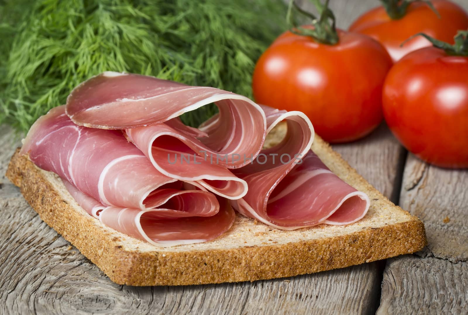 Sandwich with ham on wooden background