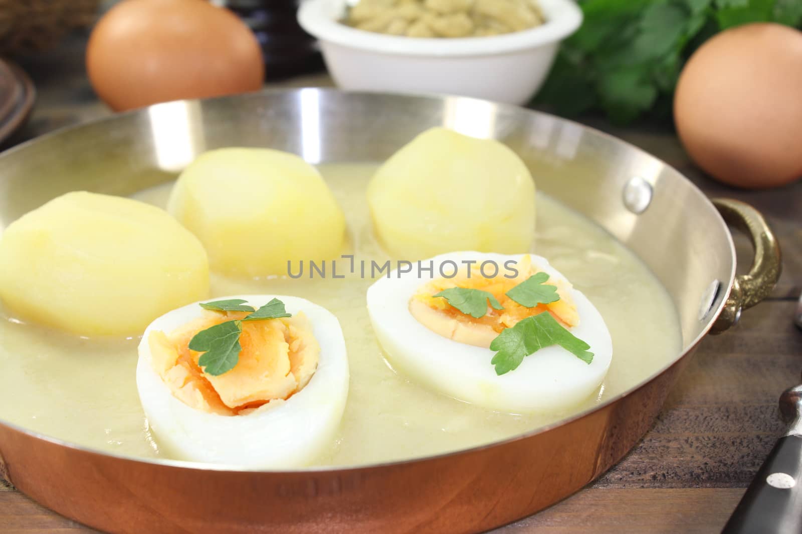 fresh sour mustard eggs with sauce, potatoes and parsley