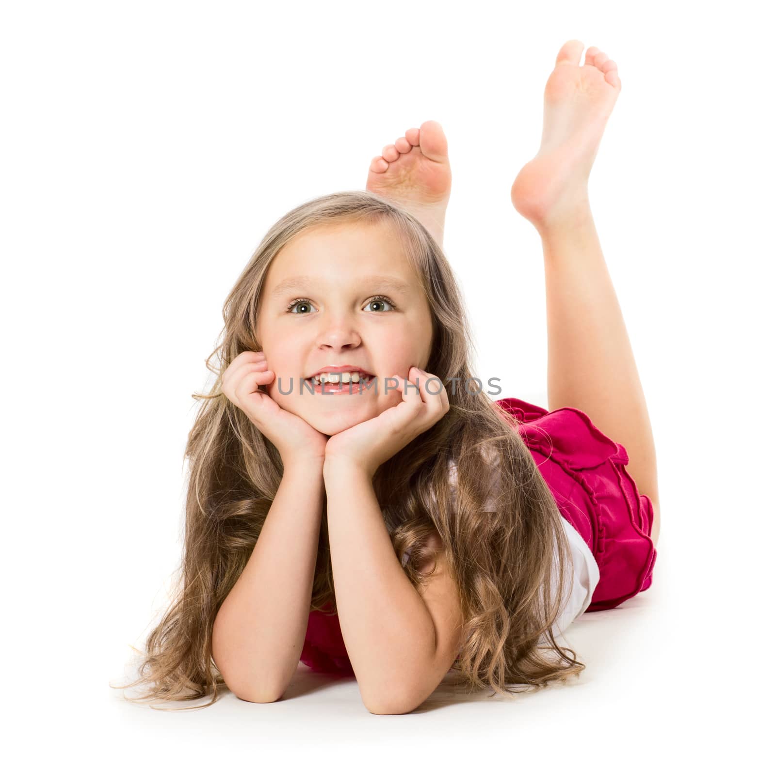 Portrait of a little girl laying on floor, isolated on white background 