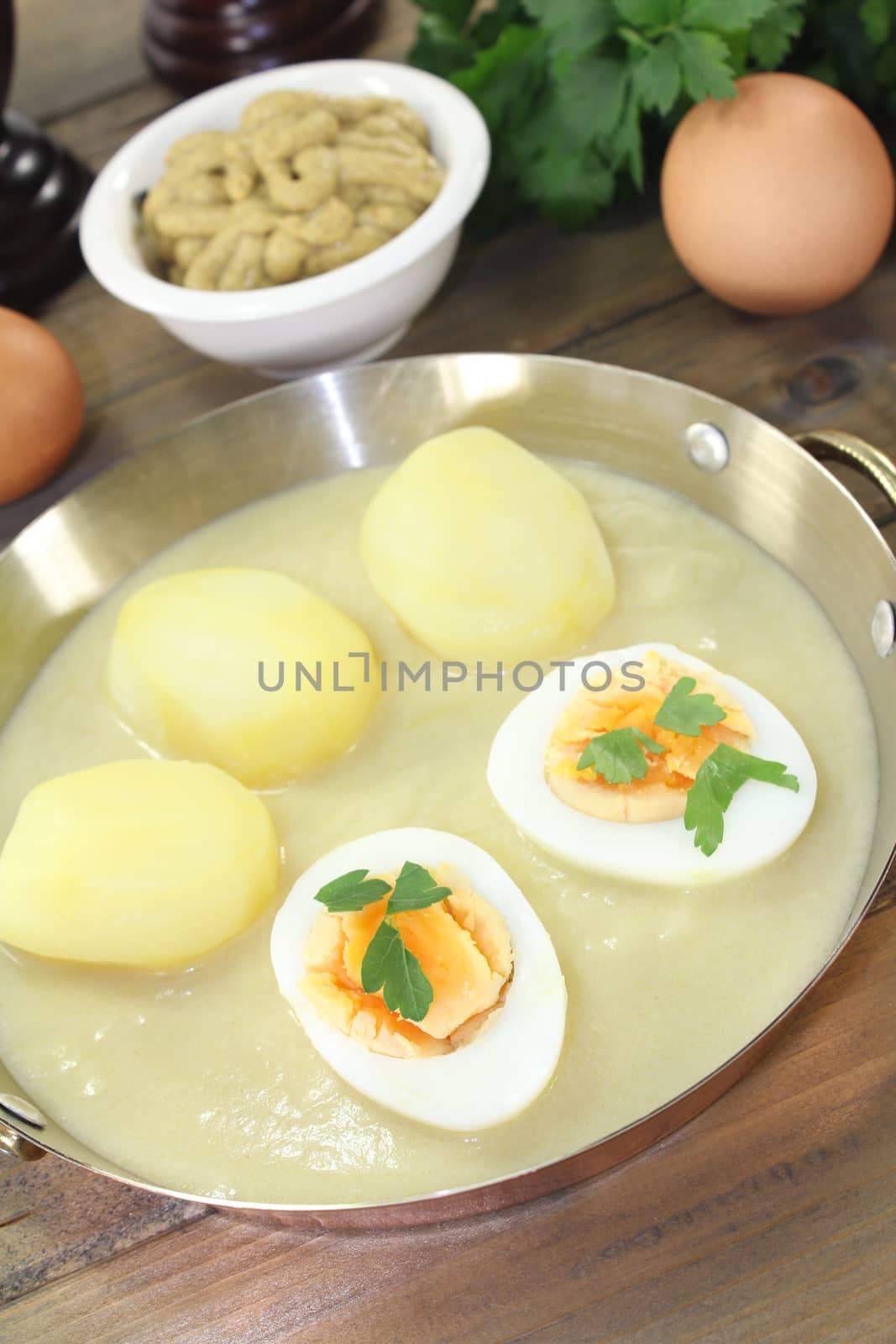 sharp mustard eggs with sauce, potatoes and parsley