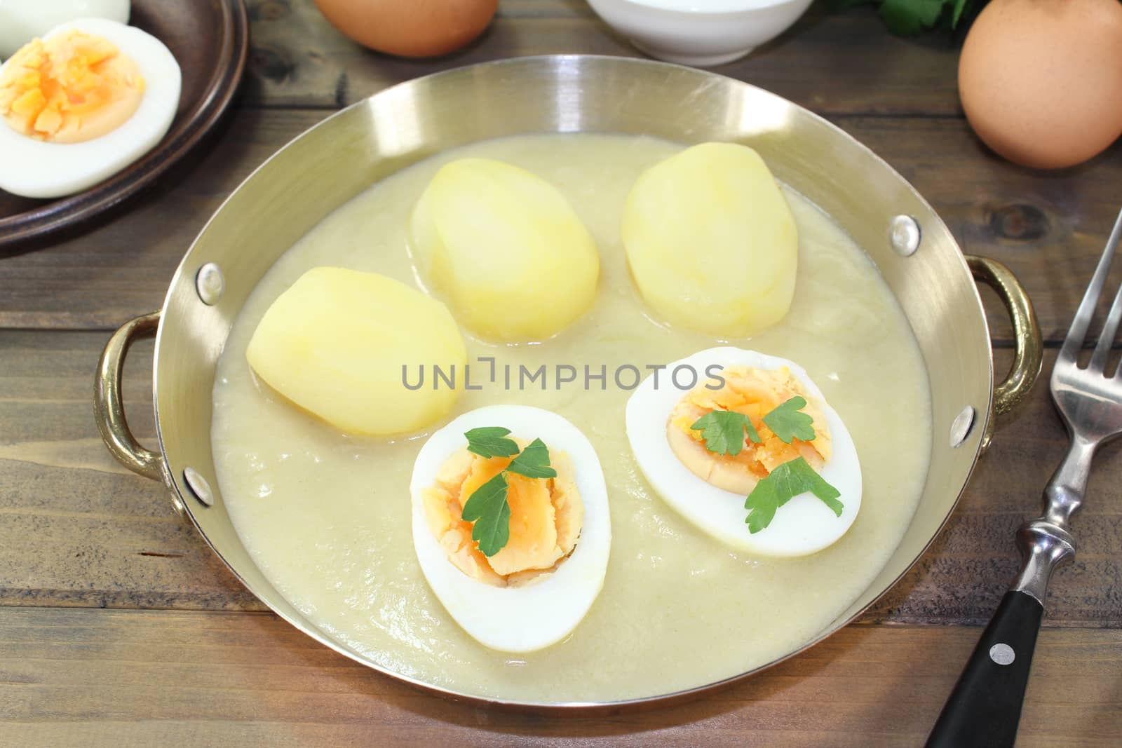 sour mustard eggs with sauce, potatoes and parsley