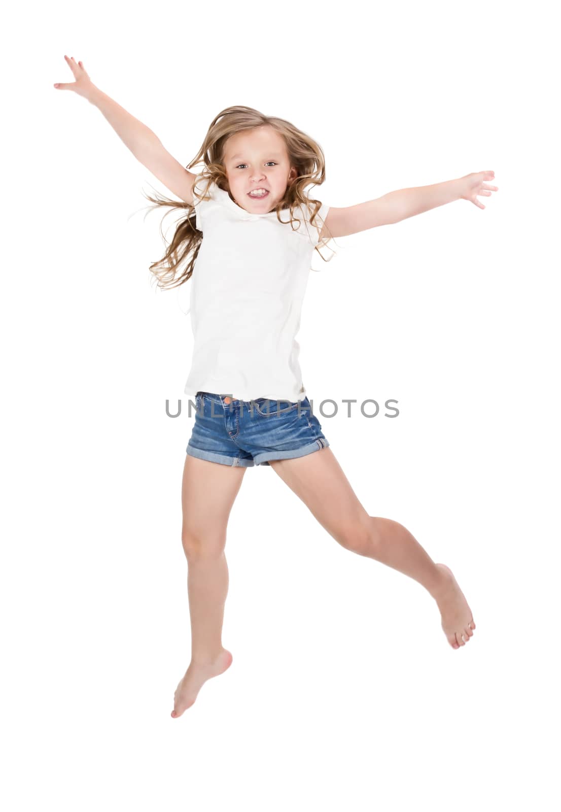 Little girl jumping over white background