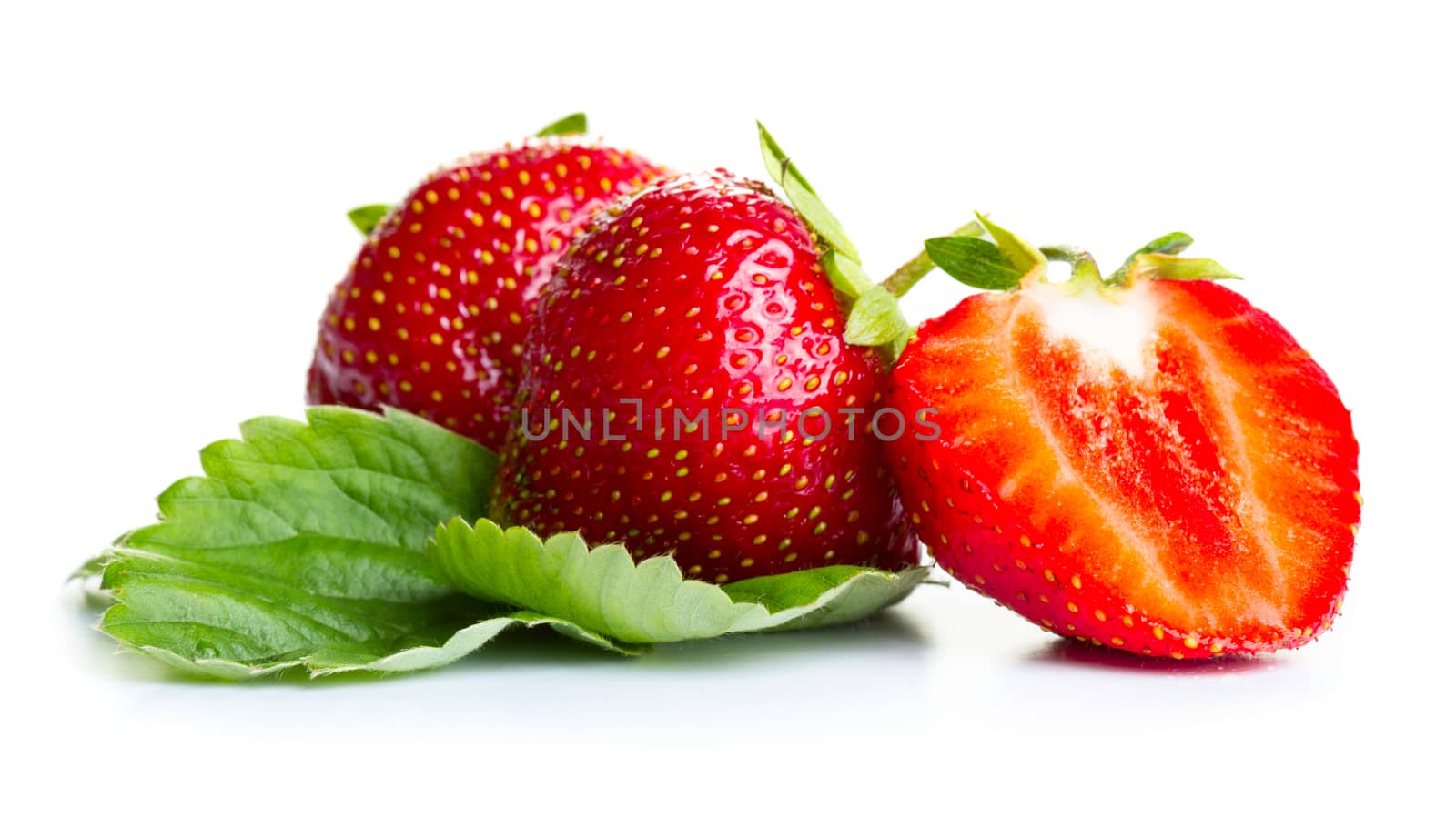 Strawberries with green leaves isolated on white background