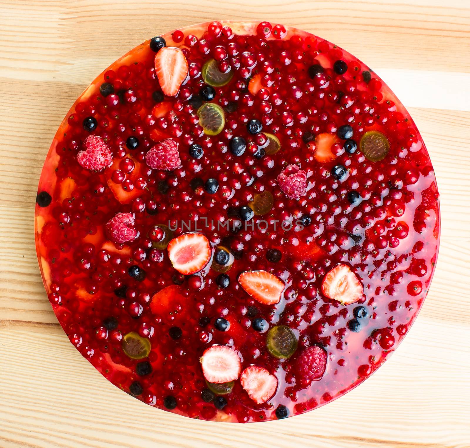 Berries cake on wooden table background