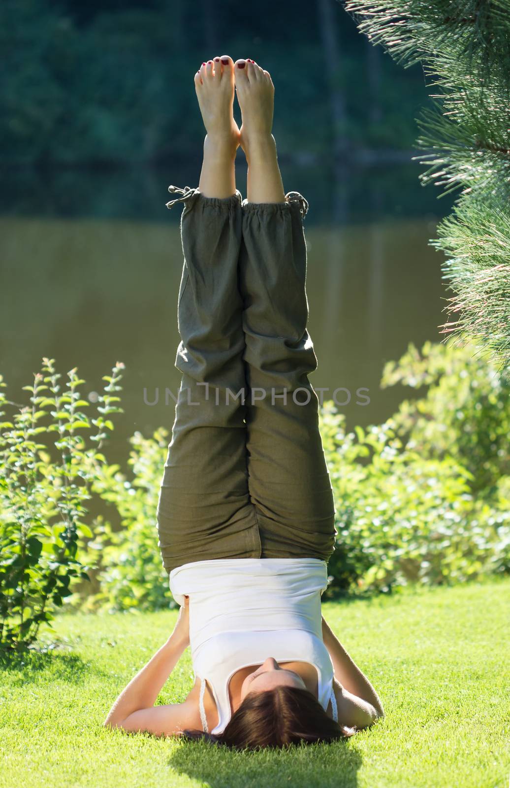 Young woman doing yoga exercise in park