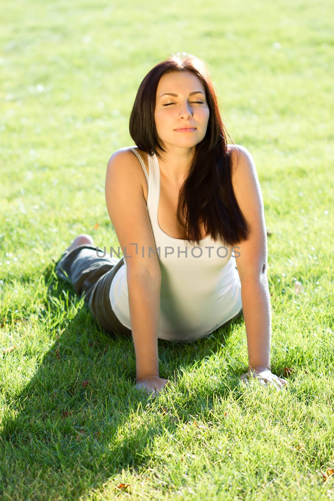 Young woman doing yoga exercise in park