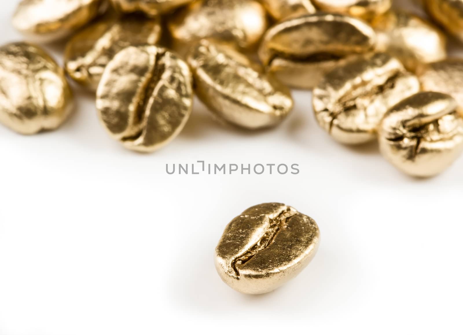 Gold coffee beans isolated on white background