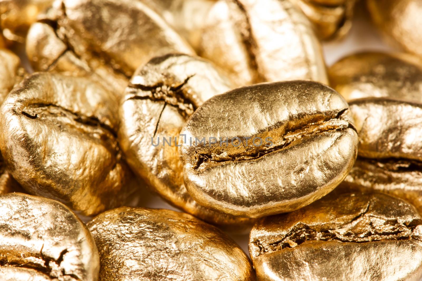 Close up view of gold coffee beans, background