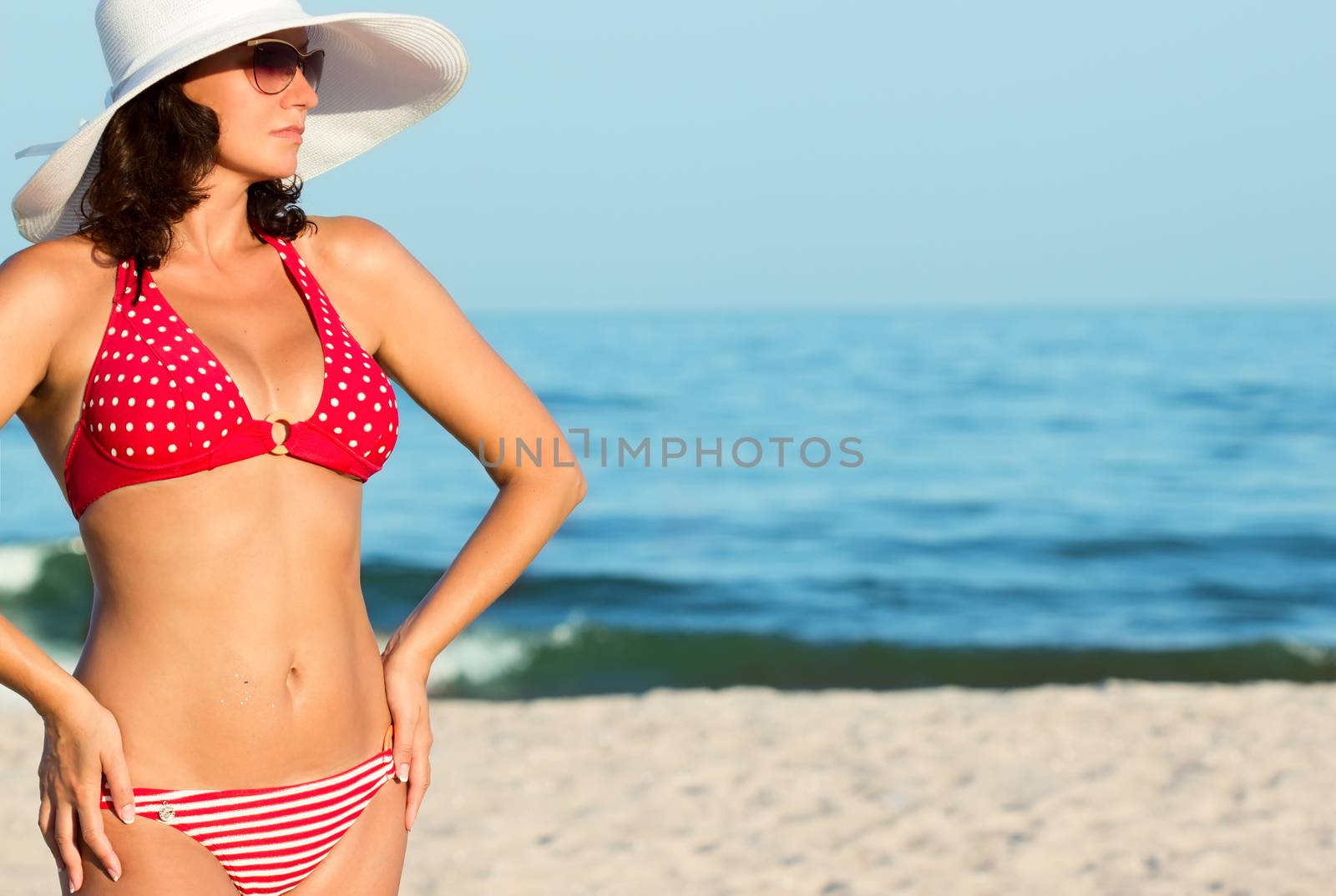 Young woman on beach by Valengilda