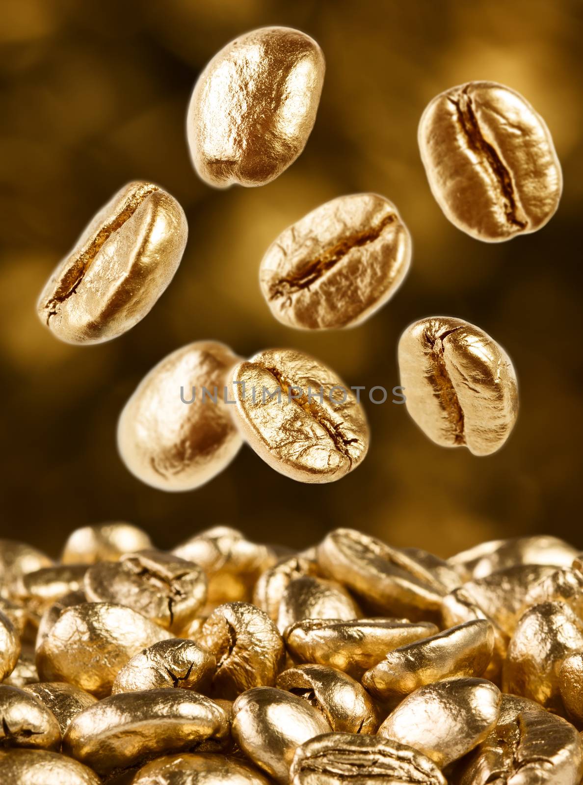 Gold coffee beans on brown background falling down