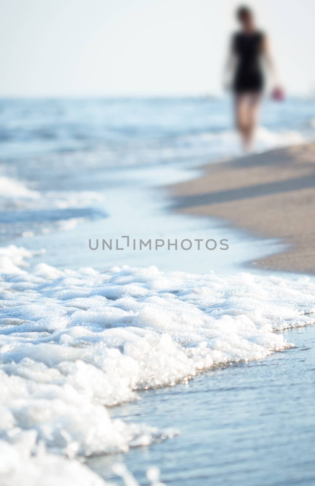 Beach with walking woman