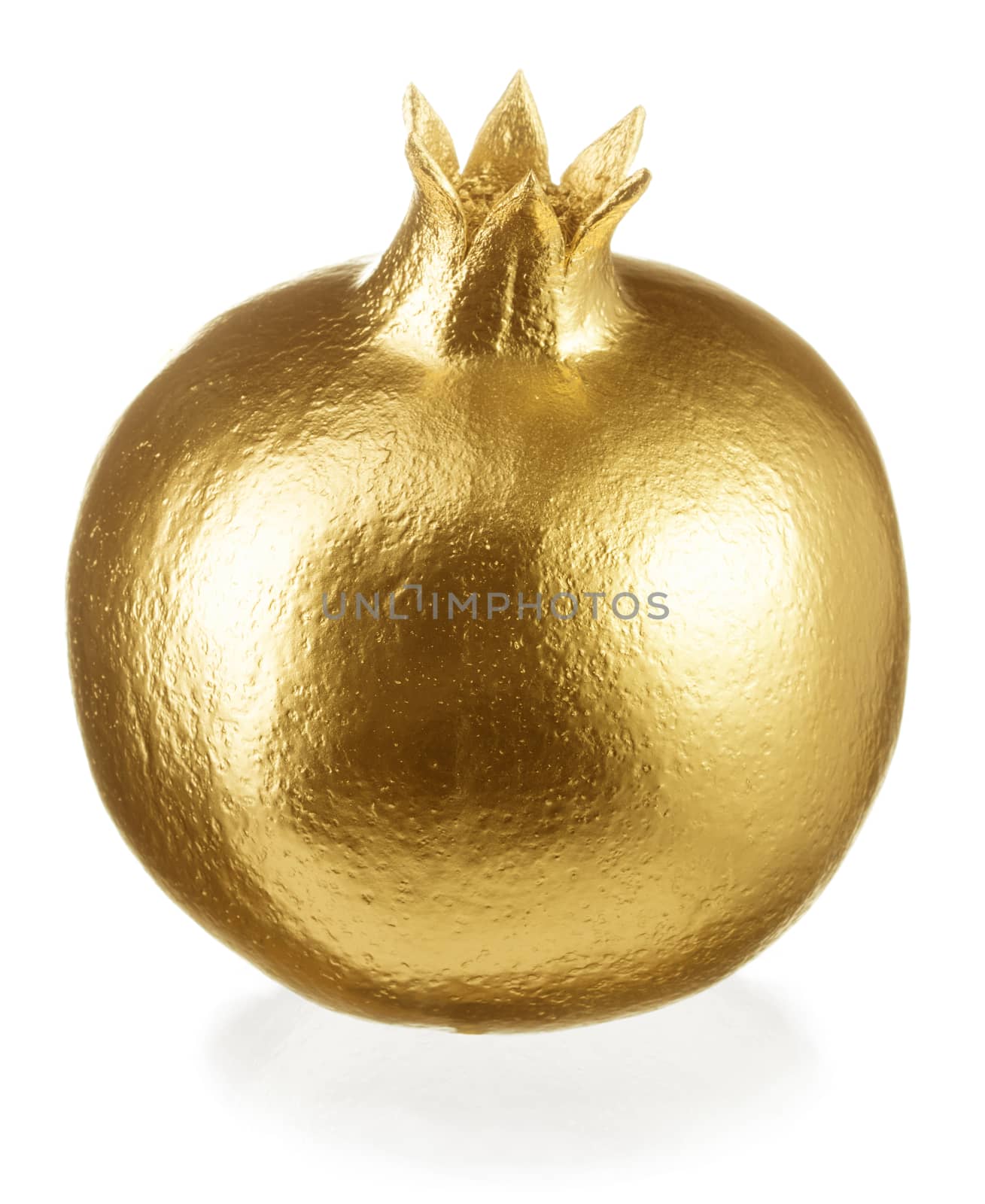 Whole gold pomegranate isolated on white