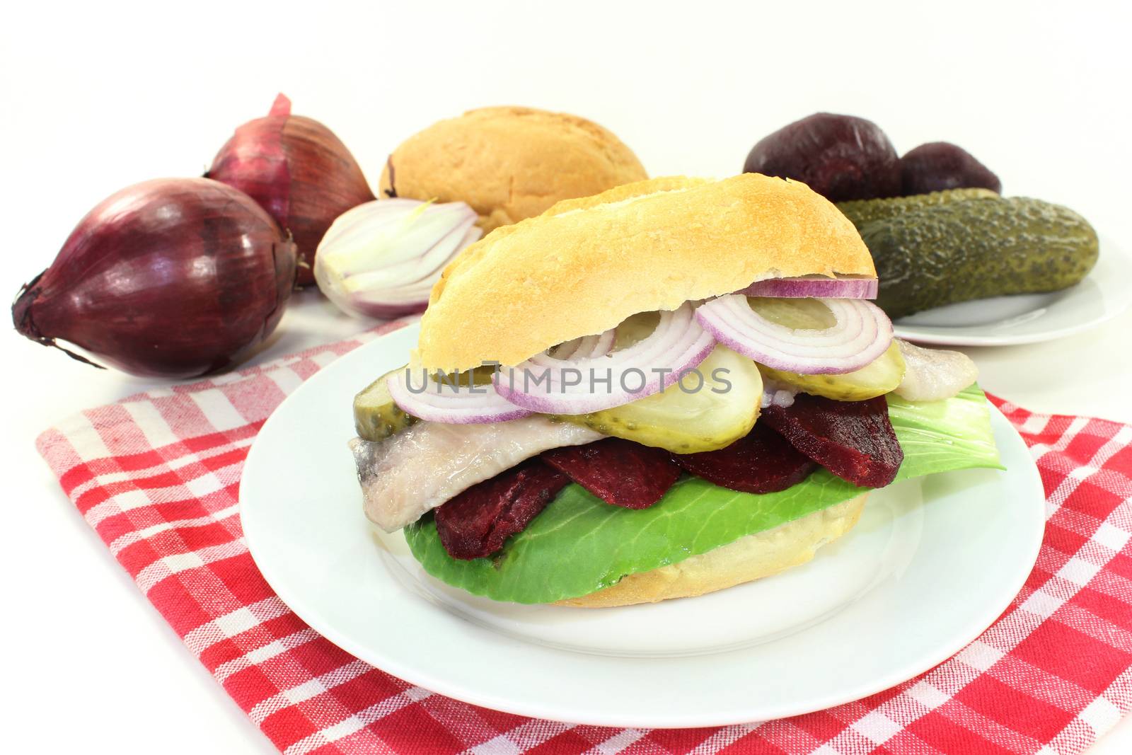 Pickled herring sandwiches with onion, beetroot and pickled cucumber