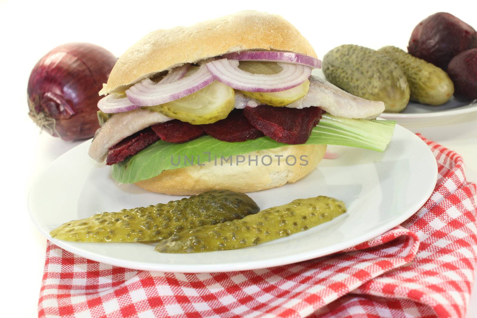 Pickled herring sandwiches with onion, beetroot and pickled cucumber