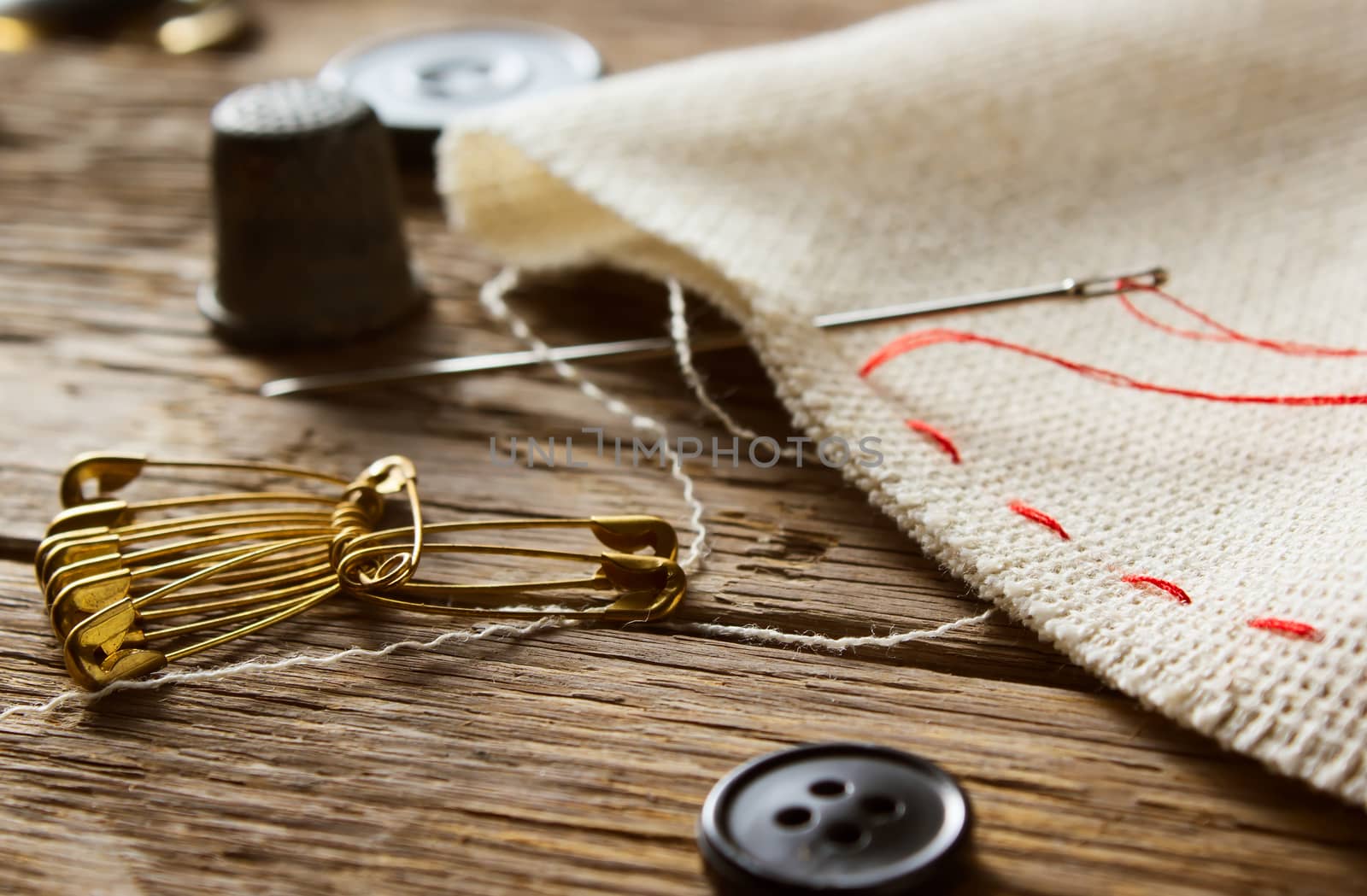 Needle and natural linen canvas texture for the background on wooden table 