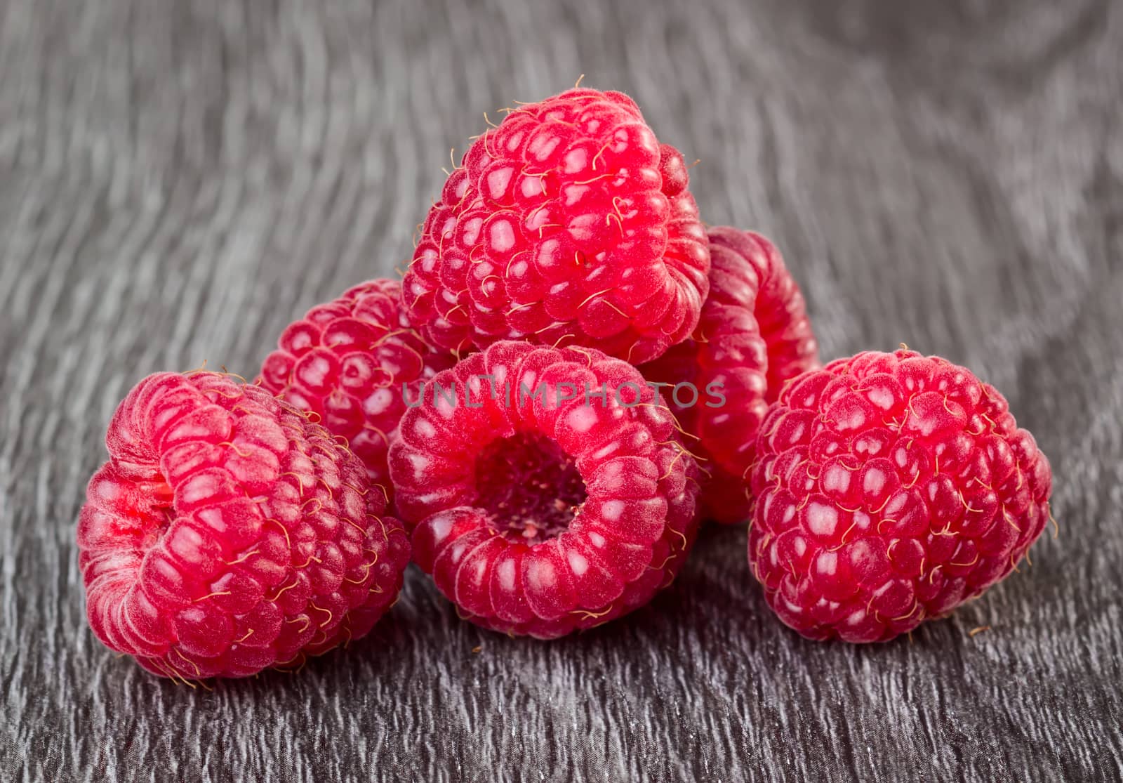 Raspberries on wooden background