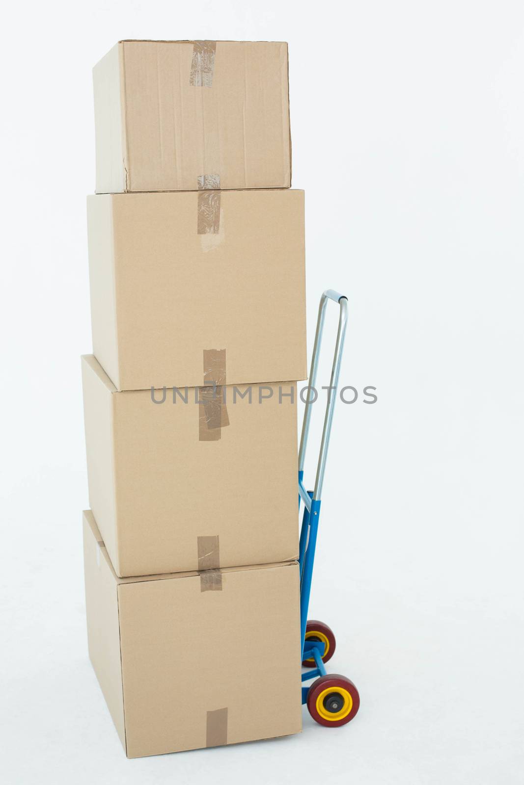 Stack of cardboard boxes on trolley over white background
