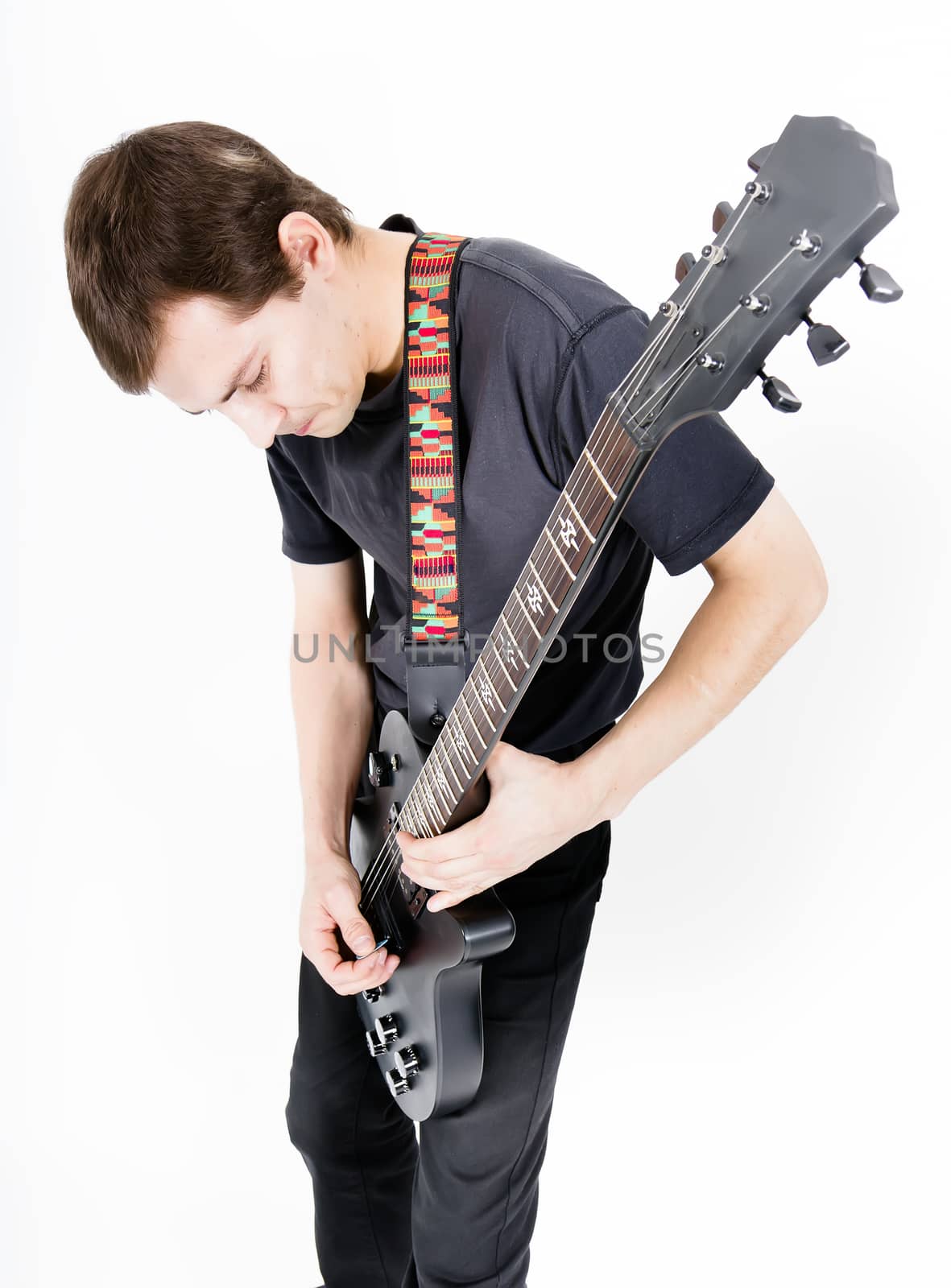 Young man with a black electric guitar