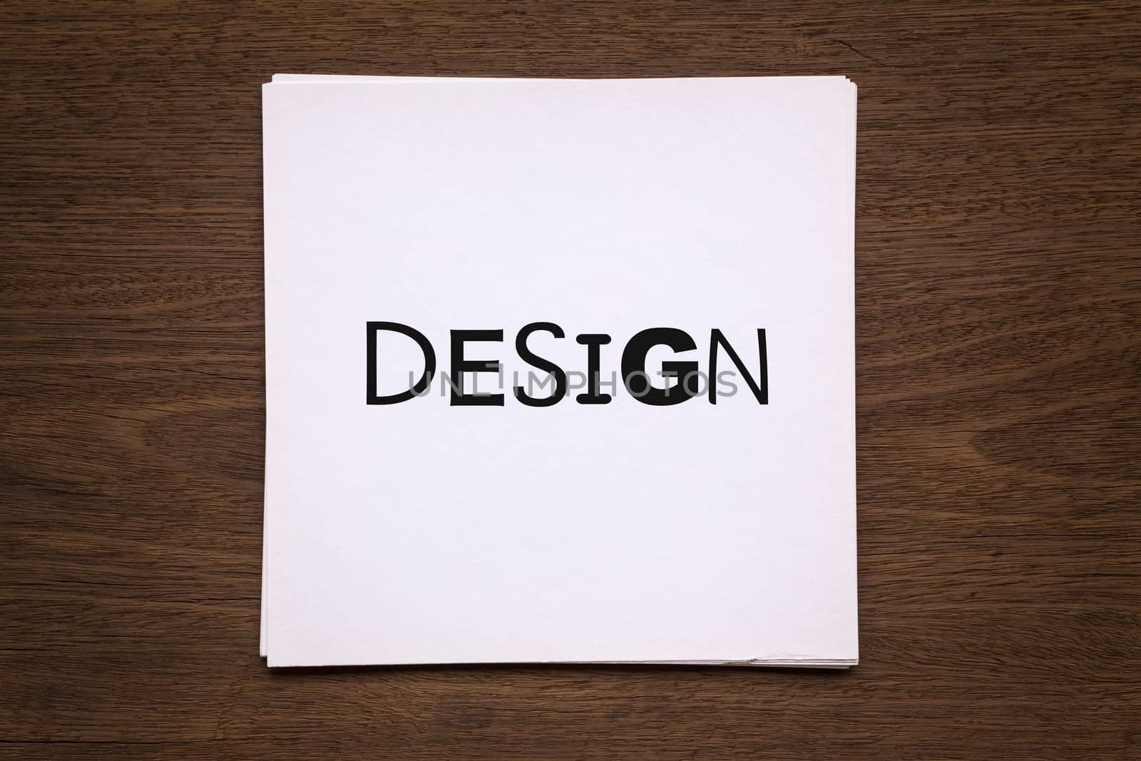 White paper cards with word " Design " on natural wood backgroun by vinnstock