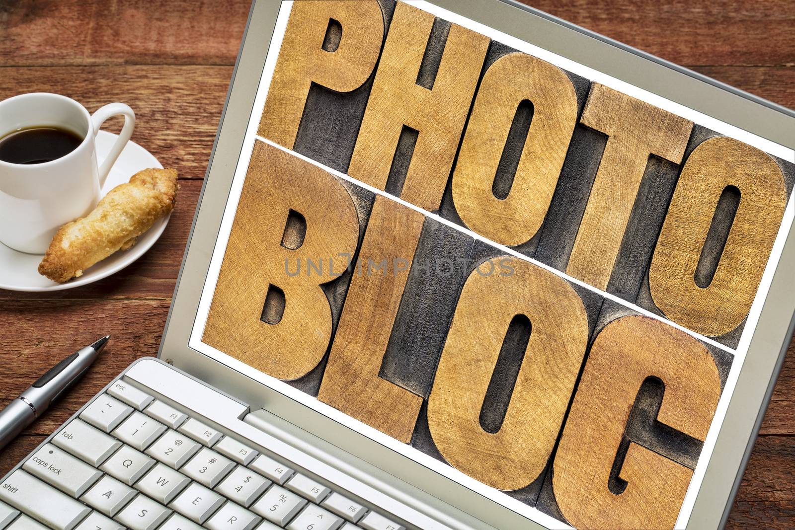 photoblog typography in letterpress wood type on a laptop screen with a cup of coffee