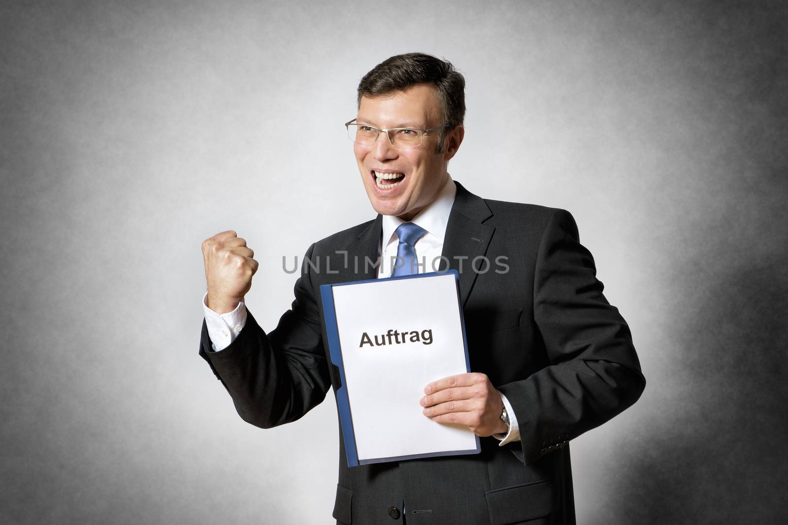 Image of happy businessman with german contract
