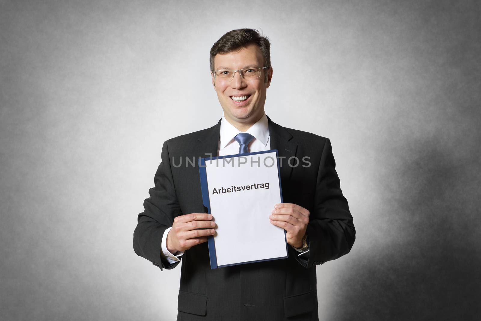 Happy business man with german employment contract