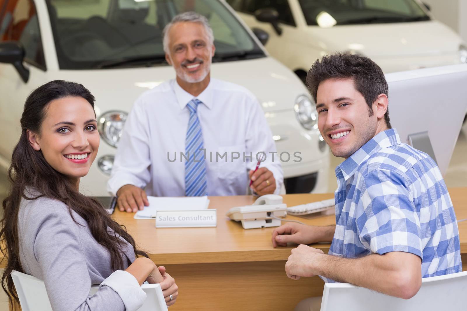 Portrait of smiling salesman and his clients by Wavebreakmedia
