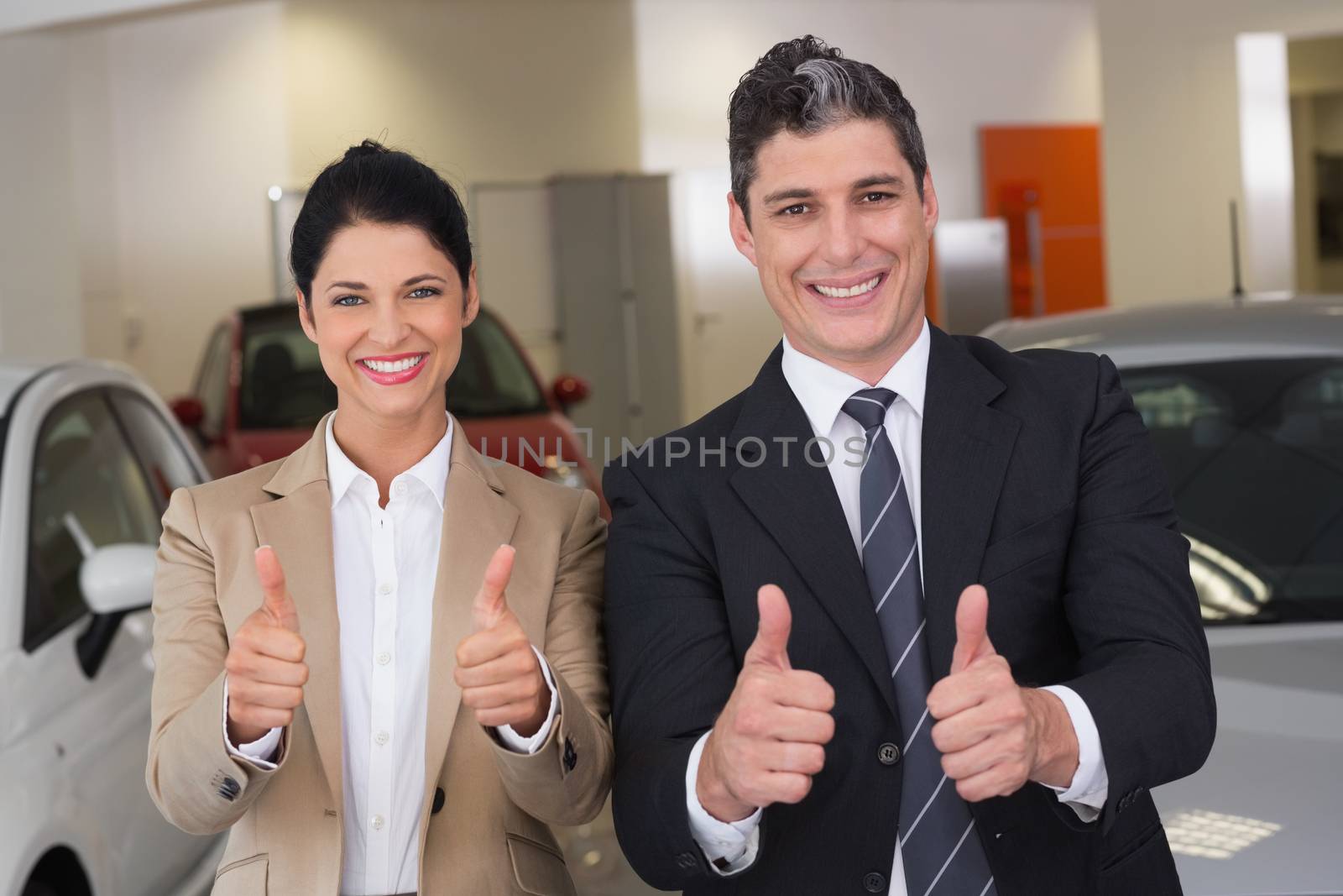 Business team giving thumbs up by Wavebreakmedia