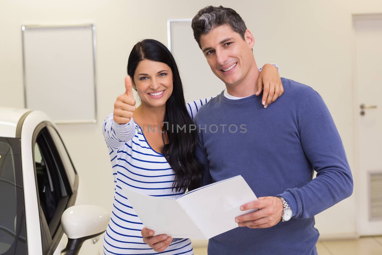 Smiling woman giving thumbs up by Wavebreakmedia